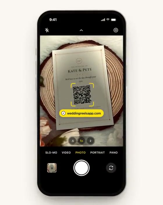 A guest scans the QR table sign with their phone camera